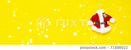 Christmas banner. Santas red suit on yellow background. Christmas banner. Santas red suit on yellow background. 71886022