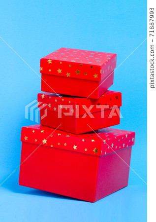 Three red gift boxes on the top of each other on blue background. Christmas gifts. Christmas and New Year's Day , group three red gift boxes. Three red gift boxes on the top of each other on blue background. Christmas gifts. Christmas and New Year's Day , group three red gift boxes. 71887993