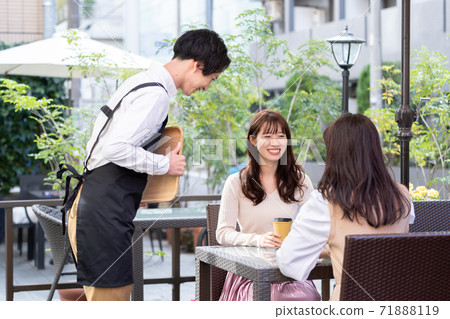 A man working in an open cafe A man working in an open cafe 71888119