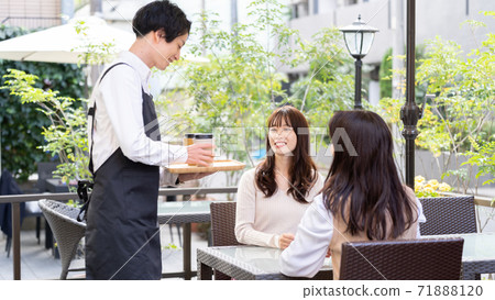 A man working in an open cafe A man working in an open cafe 71888120