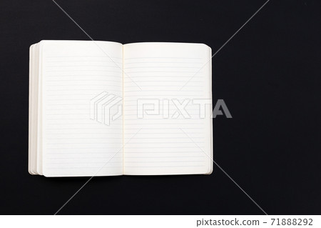 Open notebook on dark background. Top view Open notebook on dark background. Top view 71888292