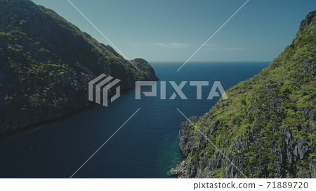 Green tropic mountain island nature at ocean bay aerial panorama view. Amazing greenery mount ranges Green tropic mountain island nature at ocean bay aerial panorama view. Amazing greenery mount ranges 71889720