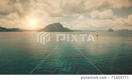 Alone yacht at ocean bay coast with sun silhouette of mountain islands at panorama aerial shot 71889771