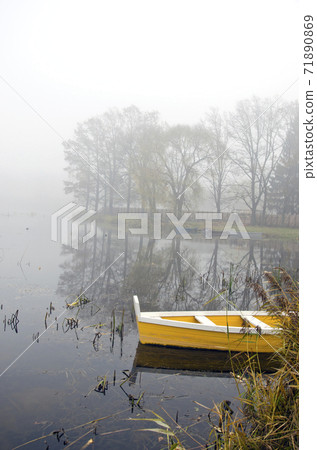 autumn lake landscape with boat and mist 71890869