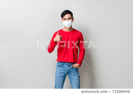 Young Asian wearing medical mask and giving thumbs up Young Asian wearing medical mask and giving thumbs up 71890948