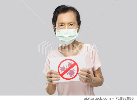woman holding an anti-virus banner 71892096