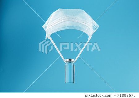 Cure for the virus and disease on a medical oil paroshut on a blue background. Cure for the virus and disease on a medical oil paroshut on a blue background. 71892673
