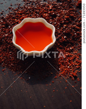 Red chilli oil in white porcelain bowl Red chilli oil in white porcelain bowl 71893950
