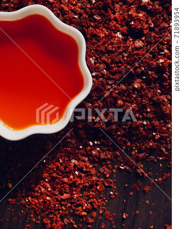 Red chilli oil in white porcelain bowl Red chilli oil in white porcelain bowl 71893954