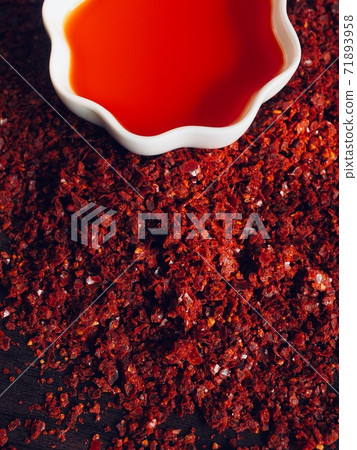 Red chilli oil in white porcelain bowl Red chilli oil in white porcelain bowl 71893958