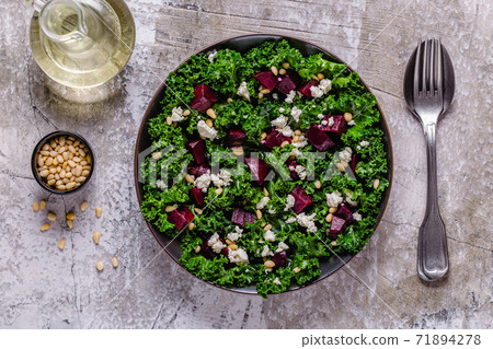 Healthy raw kale and beetroot salad with feta cheese and pine nut. Healthy raw kale and beetroot salad with feta cheese and pine nut. 71894278