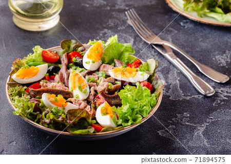 salad Nicoise with tuna, eggs, green beans, tomatoes, olives, lettuce and anchovies salad Nicoise with tuna, eggs, green beans, tomatoes, olives, lettuce and anchovies 71894575