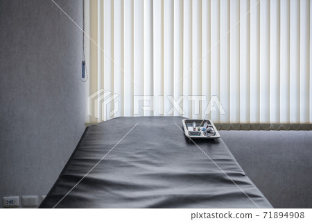 Medical instrument with syringe, vaccine, coronavirus sample blood test tube in tray on patient examination table at lab Medical instrument with syringe, vaccine, coronavirus sample blood test tube in tray on patient examination table at lab 71894908