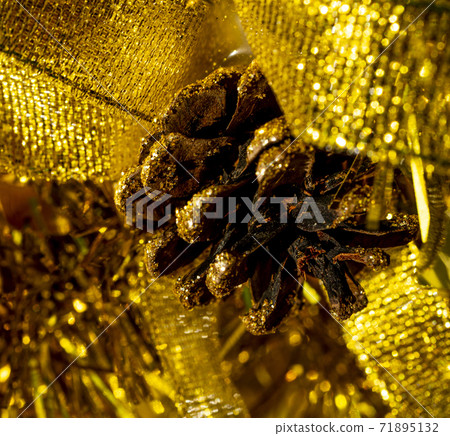 Christmas tree decorations with Pine Cone fortuna gold color on a shining background. Christmas tree decorations with Pine Cone fortuna gold color on a shining background. 71895132