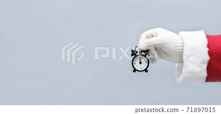 santa holding an alarm clock with 12o'clock time.  71897015