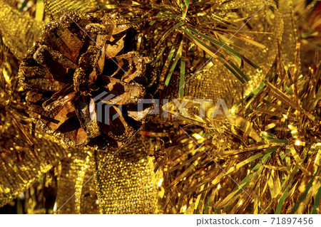 Christmas tree decorations with Pine Cone fortuna gold color on a shining background. Christmas tree decorations with Pine Cone fortuna gold color on a shining background. 71897456