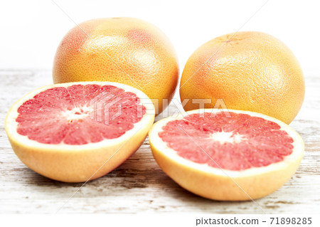 Grapefruit isolated on wooden table. Freshly harvested grapefruit Grapefruit isolated on wooden table. Freshly harvested grapefruit 71898285