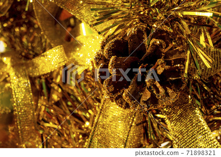 Christmas tree decorations with Pine Cone fortuna gold color on a shining background. Christmas tree decorations with Pine Cone fortuna gold color on a shining background. 71898321