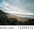 Looking down on Caswell Beach from the rock formations to the rear of the Bay on a cloudy and Autumns day. 71899155