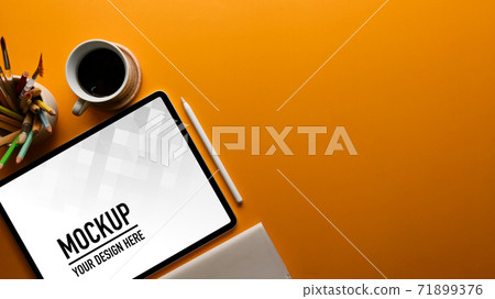Workspace with tablet, coffee cup, stationery and copy space on the table Workspace with tablet, coffee cup, stationery and copy space on the table 71899376