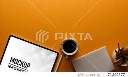 Workspace with tablet, coffee cup, stationery and copy space on the table Workspace with tablet, coffee cup, stationery and copy space on the table 71899377