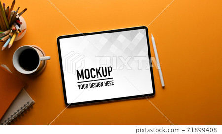 Top view of workspace with tablet, coffee cup, stationery and copy space in home office 71899408