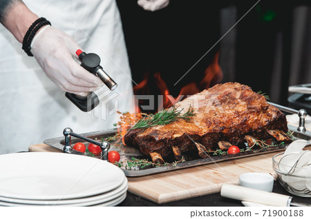 Homemade bone-in prime rib roast on wooden plank 71900188