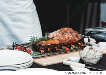 Homemade bone-in prime rib roast on wooden plank 71900189