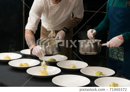 Irish colcannon served in a white bowl or traditional mashed potato with addition of kale, leek and green onion, close-up 71900372