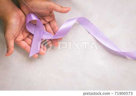 Hands holding light purple ribbon on white fabric with copy space. Testicular Cancer Awareness, Alzheimer disease, Epilepsy awareness, World Cancer Day. Healthcare or hospital and insurance concept. Hands holding light purple ribbon on white fabric with copy space. Testicular Cancer Awareness, Alzheimer disease, Epilepsy awareness, World Cancer Day. Healthcare or hospital and insurance concept. 71900573