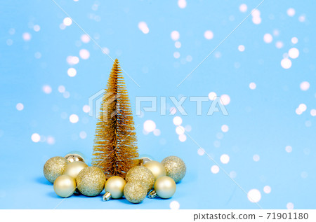 Golden Christmas tree with Christmas decorations on blue background with bokeh lights. Christmas concept. Christmas card. Golden Christmas tree with Christmas decorations on blue background with bokeh lights. Christmas concept. Christmas card. 71901180