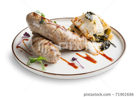 Fried Weisswurst (white veal sausage) with marinated cabbage and sea wed Fried Weisswurst (white veal sausage) with marinated cabbage and sea wed 71901686
