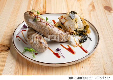 Fried Weisswurst (white veal sausage) with marinated cabbage and sea wed 71901687