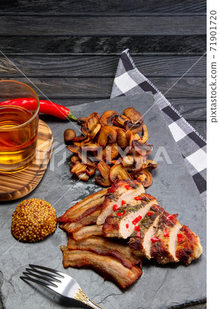 Top view of fried fillet with mushrooms and slices of bacon served with pepper moonshine. Unhealthy but so tasty country food. Top view of fried fillet with mushrooms and slices of bacon served with pepper moonshine. Unhealthy but so tasty country food. 71901720