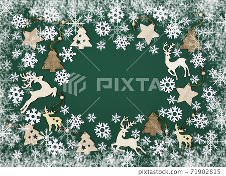 Christmas wooden decorations on green tidewater background with snowlakes winter frame 71902815