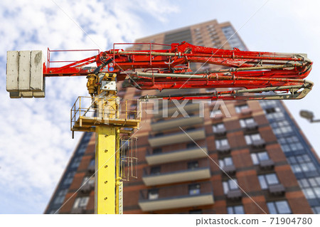 Construction concrete pump (pump truck ) with multi-storey building under construction (new residential complex) on the background, Moscow, Russia 71904780