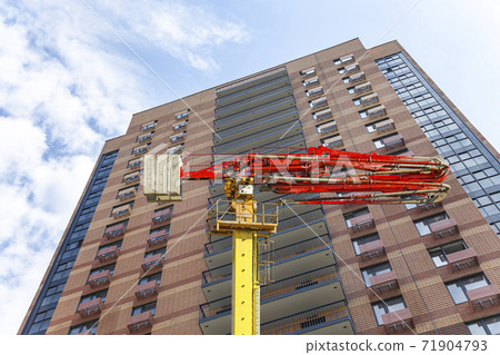 Construction concrete pump (pump truck ) with multi-storey building under construction (new residential complex) on the background, Moscow, Russia Construction concrete pump (pump truck ) with multi-storey building under construction (new residential complex) on the background, Moscow, Russia 71904793