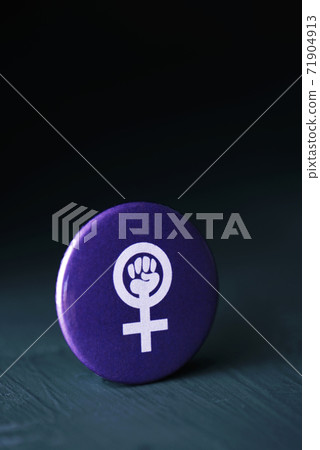 the women power symbol in a violet pin button the women power symbol in a violet pin button 71904913