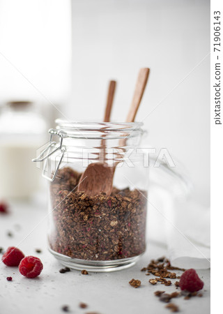 chocolate granola with nuts and seeds in a glass jar chocolate granola with nuts and seeds in a glass jar 71906143