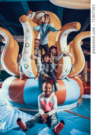 Cheerful children are smiling while having fun. Cheerful children are smiling while having fun. 71907163