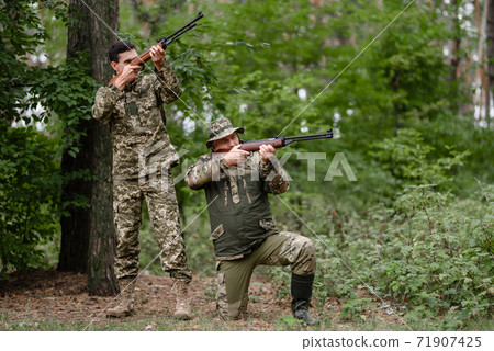 Gamebird Hunt in Forest Shooters are Taking Aim. 71907425