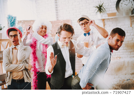 Guys are having a party together and having fun. 71907427