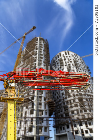 Construction concrete pump (pump truck) with multi-storey building under construction with scaffolding (new residential complex) on the background, Moscow, Russia 71908183