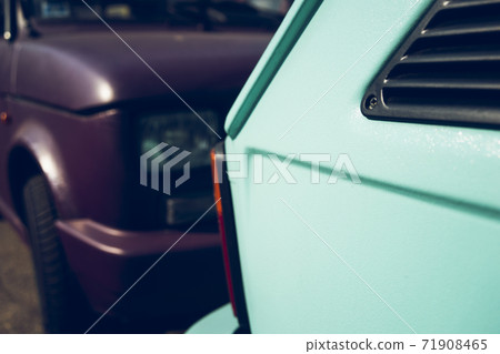 Two small cars of different colors on the road Two small cars of different colors on the road 71908465