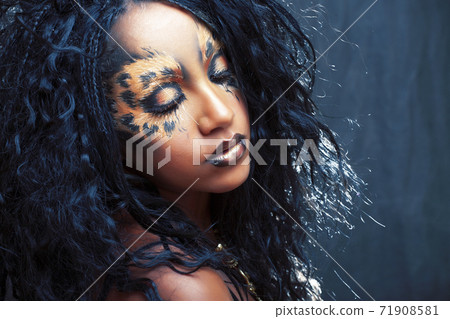 beauty afro girl with cat make up, creative leopard print on face closeup halloween woman 71908581
