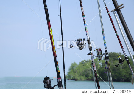 PORT DICKSON, MALAYSIA -APRIL 28, 2017: Fishing rods complete with the motor used by fisherman. These rods are used to fish in coastal fishing. PORT DICKSON, MALAYSIA -APRIL 28, 2017: Fishing rods complete with the motor used by fisherman. These rods are used to fish in coastal fishing. 71908749