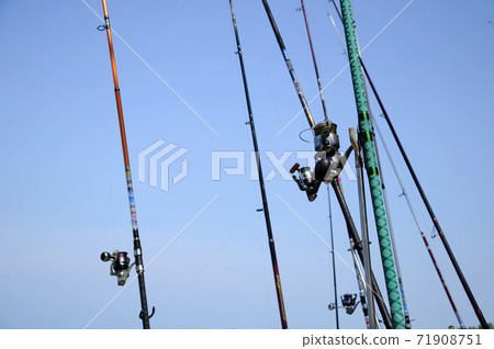 PORT DICKSON, MALAYSIA -APRIL 28, 2017: Fishing rods complete with the motor used by fisherman. These rods are used to fish in coastal fishing. PORT DICKSON, MALAYSIA -APRIL 28, 2017: Fishing rods complete with the motor used by fisherman. These rods are used to fish in coastal fishing. 71908751