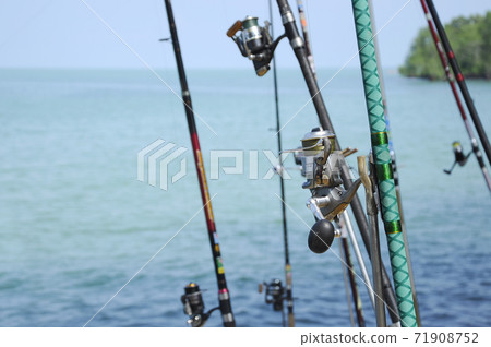 PORT DICKSON, MALAYSIA -APRIL 28, 2017: Fishing rods complete with the motor used by fisherman. These rods are used to fish in coastal fishing. 71908752