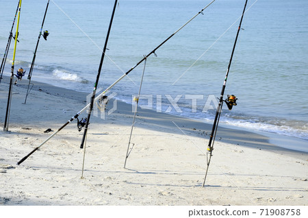 PORT DICKSON, MALAYSIA -APRIL 28, 2017: Fishing rods complete with the motor used by fisherman. These rods are used to fish in coastal fishing. PORT DICKSON, MALAYSIA -APRIL 28, 2017: Fishing rods complete with the motor used by fisherman. These rods are used to fish in coastal fishing. 71908758