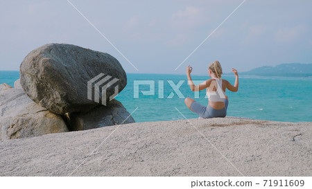 Young Woman Practices Yoga 71911609